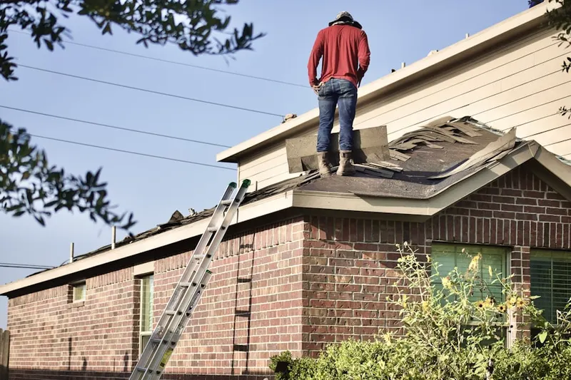 Professional roofer working on a residential roof in Whisperren Oaks